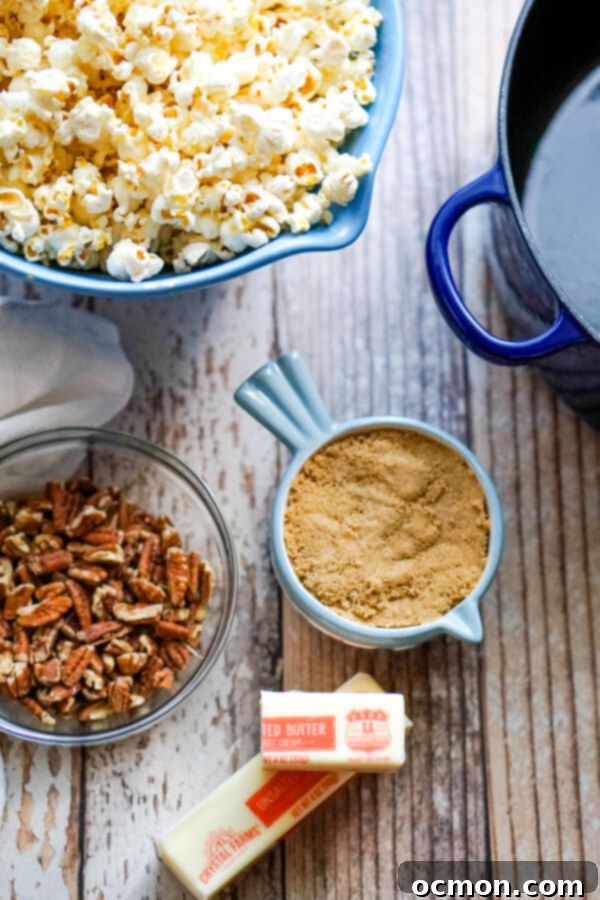 A bowl of popped popcorn next to pecans, brown sugar, and butter. 