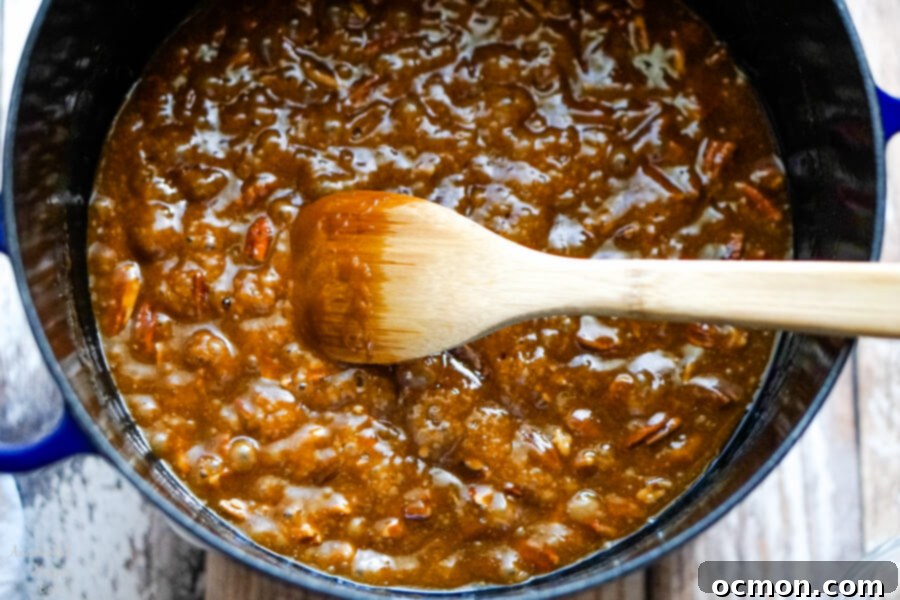 A dutch oven filled with caramel that is boiling. 