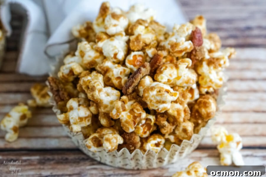 A paper cup with a serving of Salted Caramel Pecan Popcorn