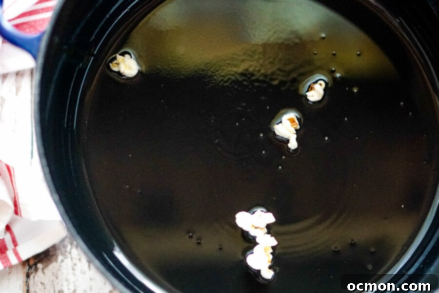 When the test kernels pop you'll know the oil is the right temperature to pop the popcorn.