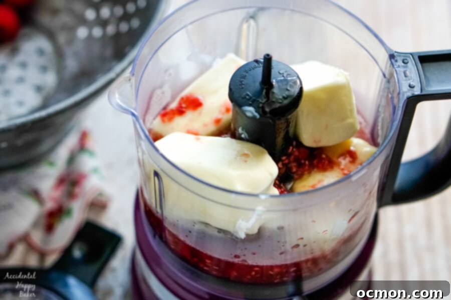 Whipped Raspberry Honey Butter 6 All three ingredients – cooled raspberry honey syrup and softened unsalted butter – are combined in a food processor, ready for blending.