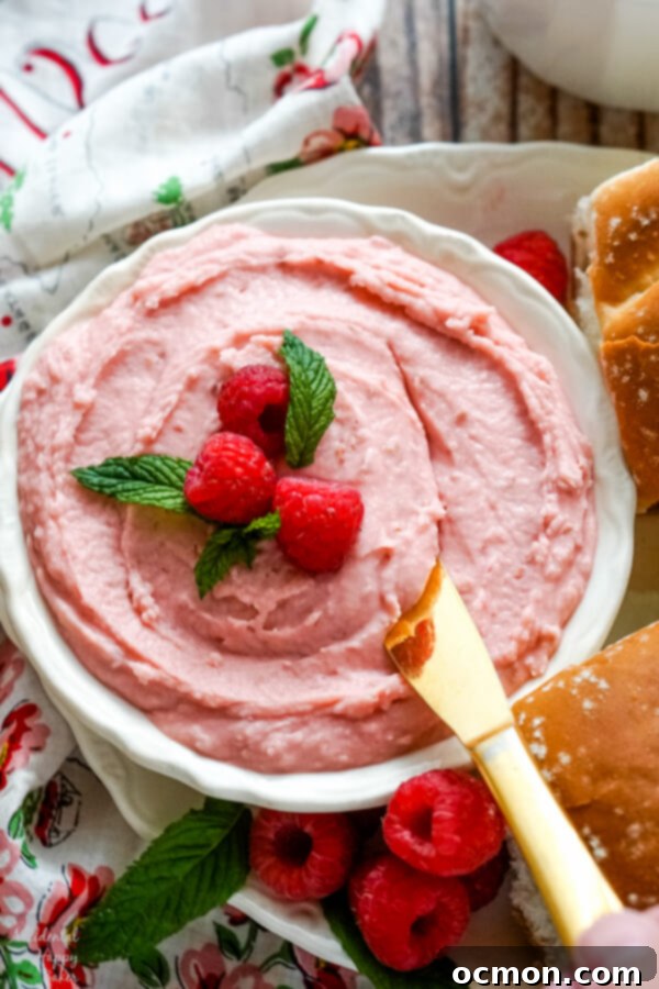 Whipped Raspberry Honey Butter 8 A bowl of raspberry honey butter with a butter knife, ready to be spread.