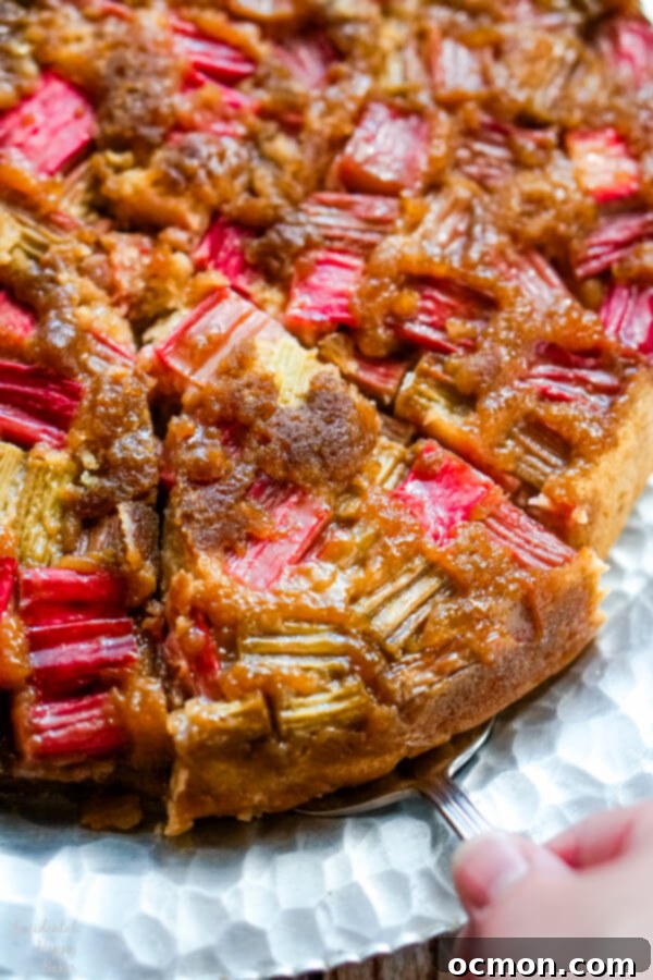 Zingy Rhubarb Ginger Upside Down Cake 2 A slice of rhubarb ginger upside down cake being served.