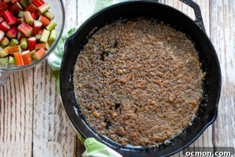 Zingy Rhubarb Ginger Upside Down Cake 4 A cast iron skillet with melted butter, ginger and brown sugar.