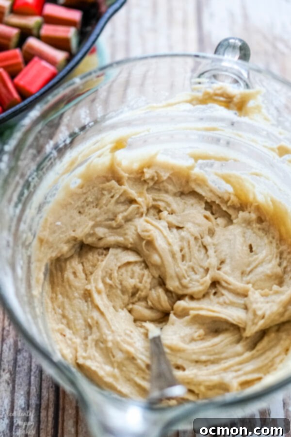 Zingy Rhubarb Ginger Upside Down Cake 6 A mixing bowl full of cake batter.