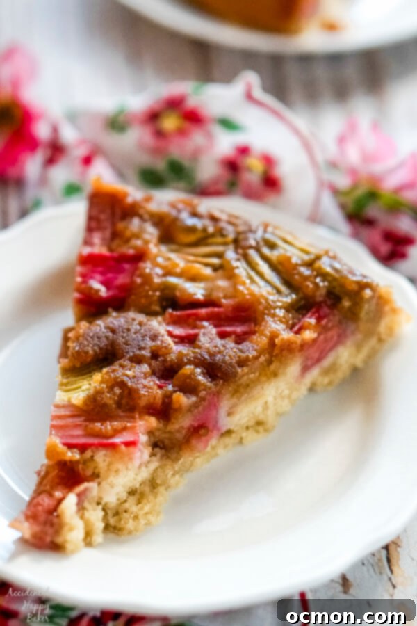 Zingy Rhubarb Ginger Upside Down Cake 9 A slice of rhubarb ginger upside down cake on a white plate.