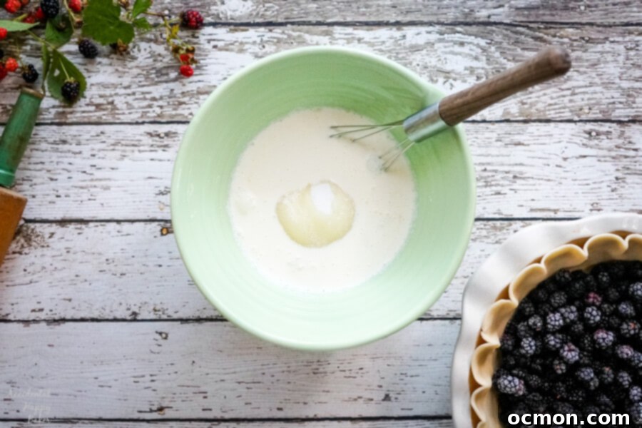 Luscious Blackberry Cream Pie 5 A green mixing bowl with the ingredients to make the filling for the pie.