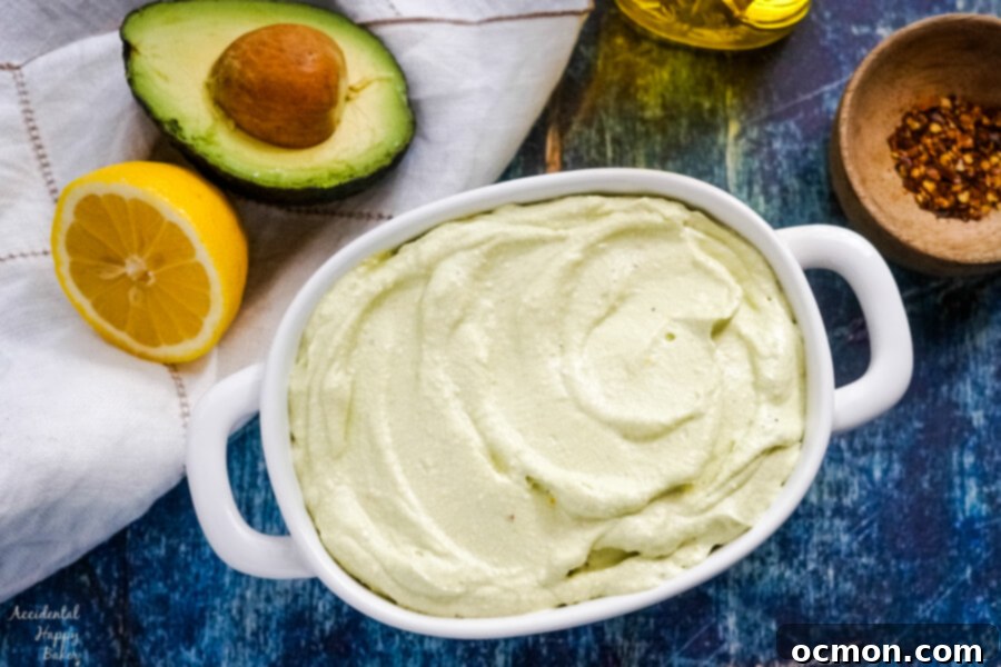 Bright Lemon Feta Dip 5 A bowl of lemon feta dip sitting next to half an avocado and lemon.