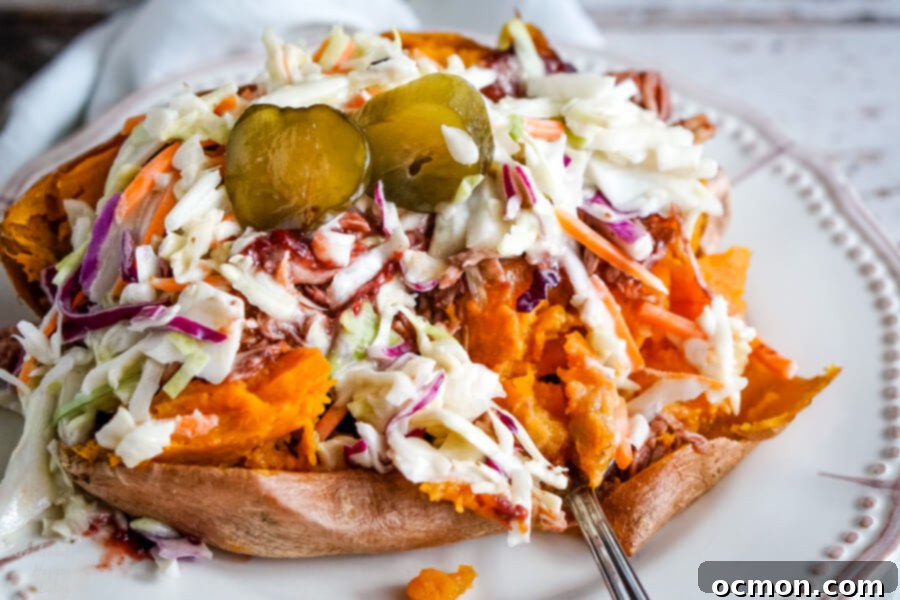 A fork cutting into the side of a BBQ stuffed sweet potato