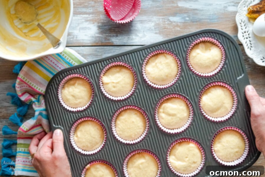 Peanut Butter Banana Bliss Cupcakes 3 Cupcake batter scooped into liners, ready to be baked into delicious banana cupcakes.