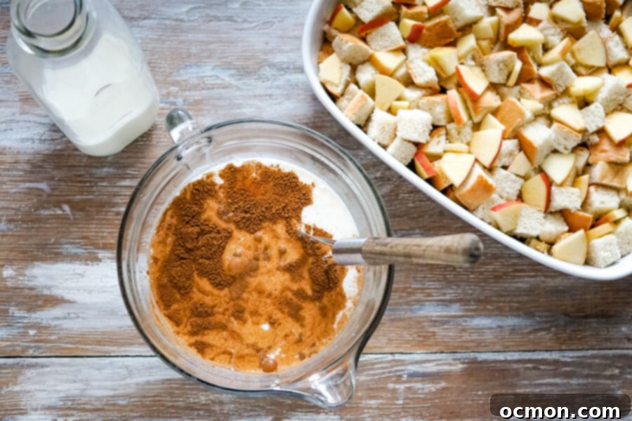 Warm Cinnamon Apple French Toast Bake 7 A mixing bowl with milk, eggs, cinnamon and sugar ready to be whisked.