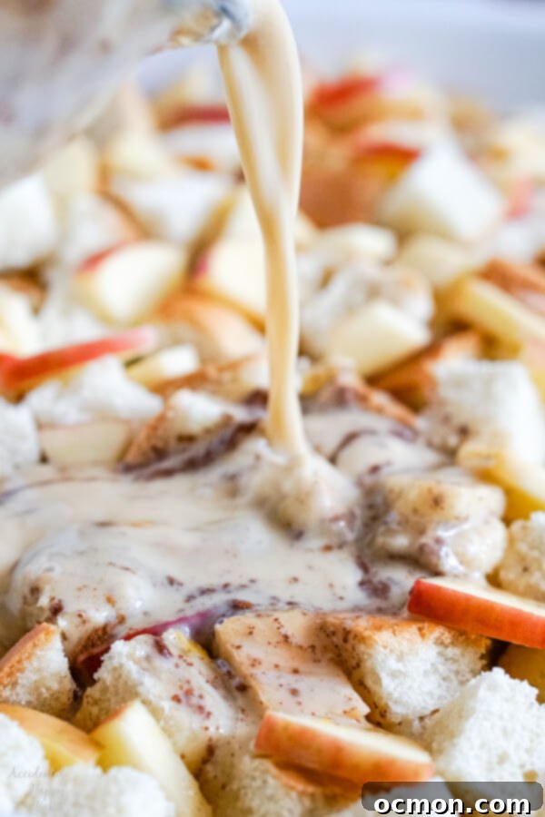 Warm Cinnamon Apple French Toast Bake 8 A close up image of pouring the milk mixture onto the bread and apples.
