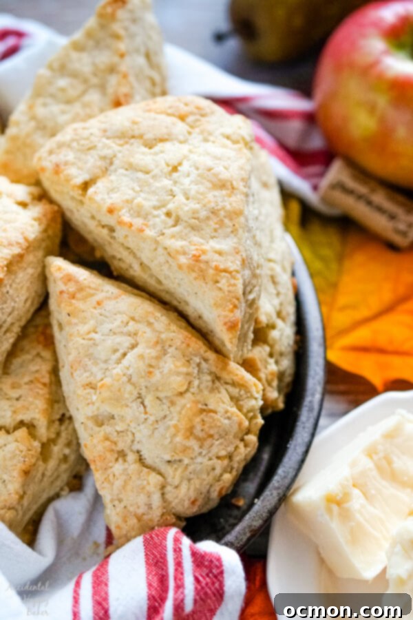 Close-up of golden brown, flaky white cheddar scones cooling in a baking pan