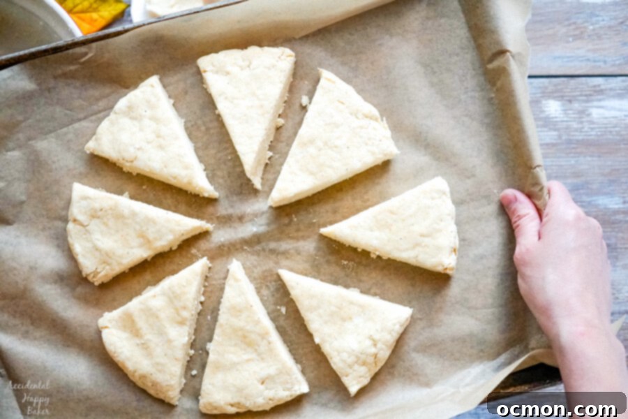 Eight scone wedges gently separated on a baking sheet, ready for the oven