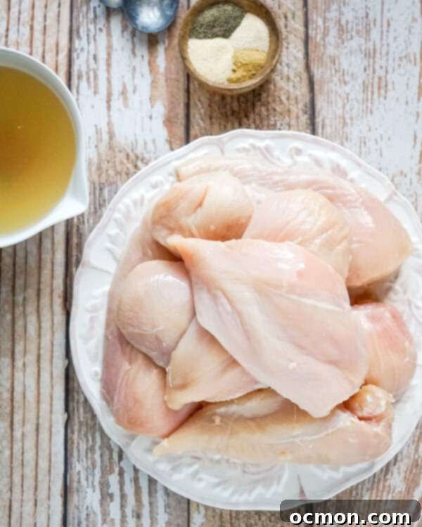 A plate of trimmed fresh chicken breasts. 