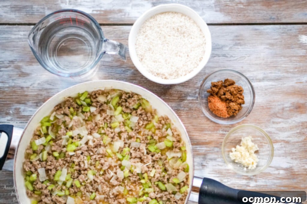 After the sausage is cooked, water, rice, seasonings and garlic are added. 