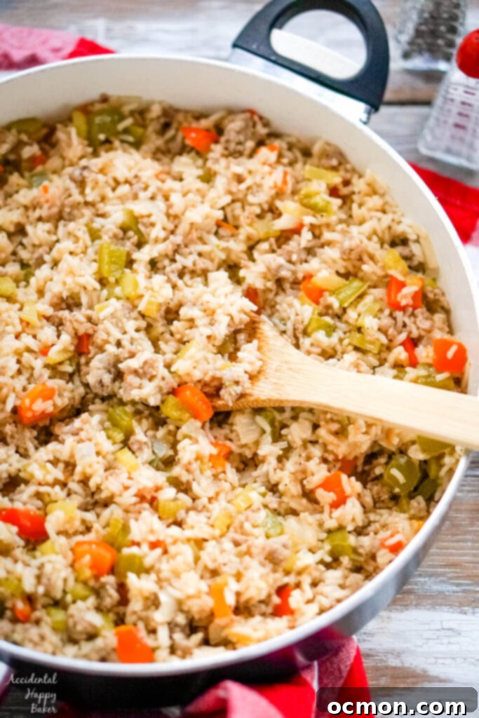 Red and green bell peppers are added to the rice mixture next. 