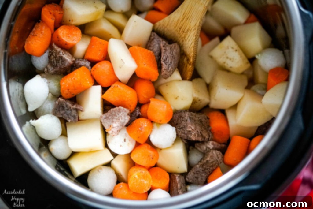 Potatoes, carrots, and pearl onions are added to the instant pot. 