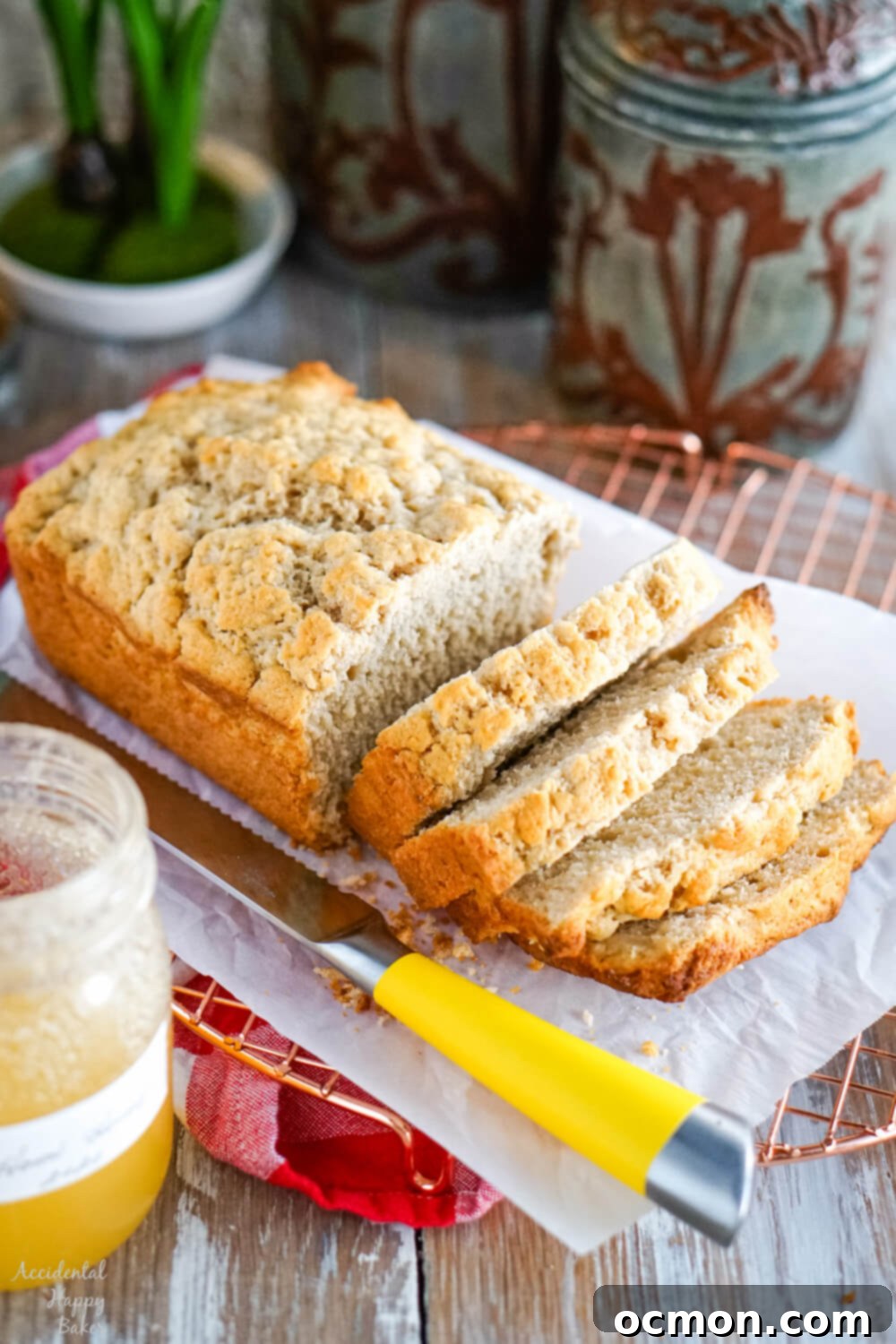 A slice of golden honey beer bread on a plate, showing its tender crumb and crust.