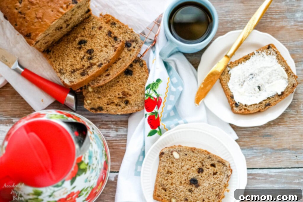 Welsh Bara Brith Tea Bread 2 A beautifully sliced loaf of Bara Brith, or Welsh tea bread, resting beside a steaming cup of tea and a classic teapot.