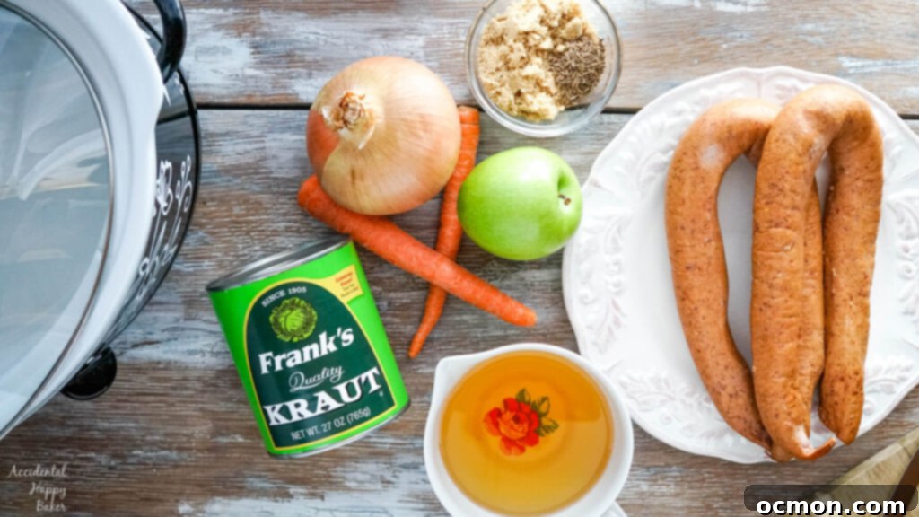 All the fresh ingredients laid out for slow cooker kielbasa and sauerkraut, including sliced kielbasa, drained sauerkraut, sliced carrots, diced apple, diced onion, brown sugar, caraway seeds, and apple juice.