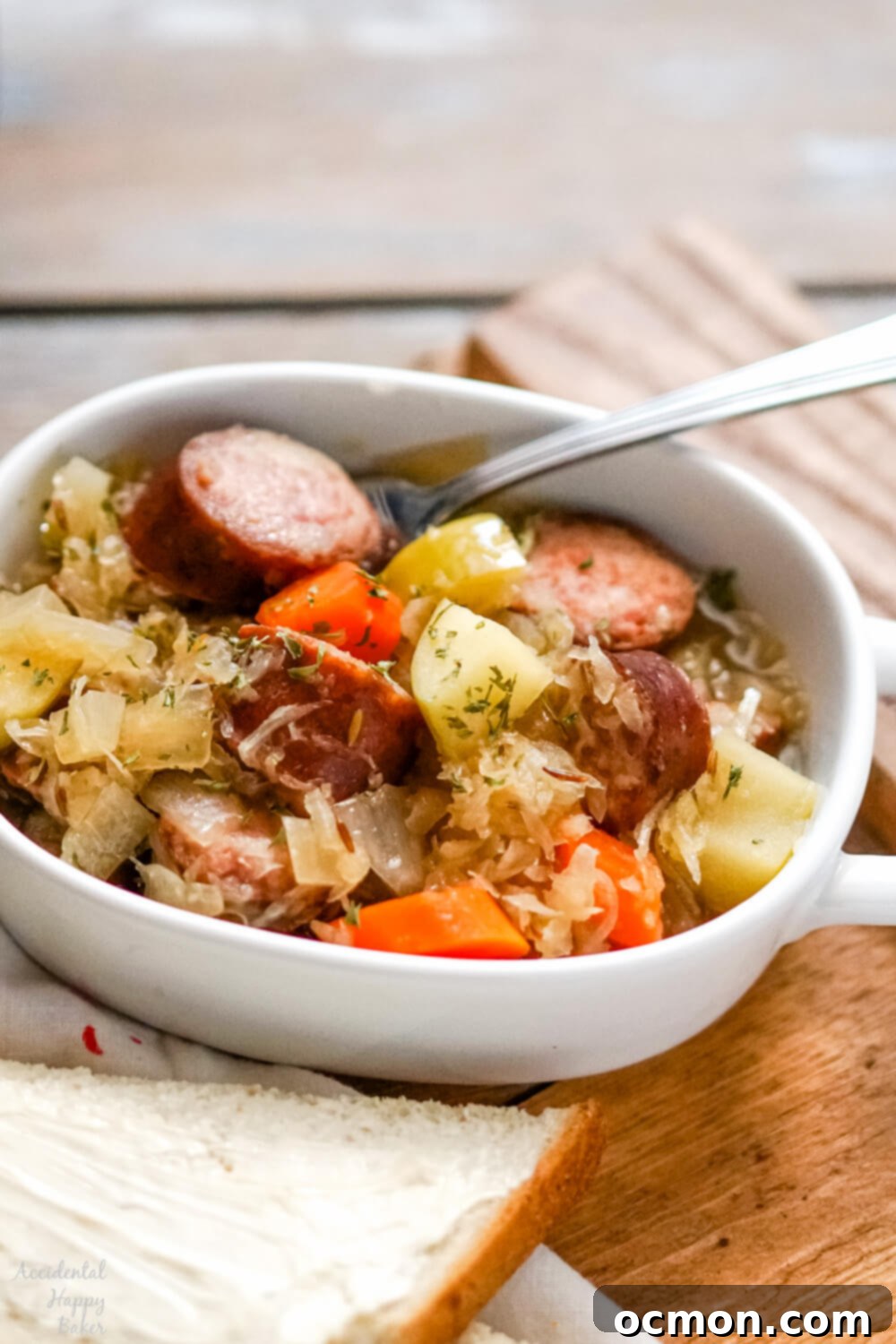 Kielbasa and sauerkraut are slow simmered with veggies, brown sugar, caraway and apple juice for a deliciously easy and comforting meal in the slow cooker.