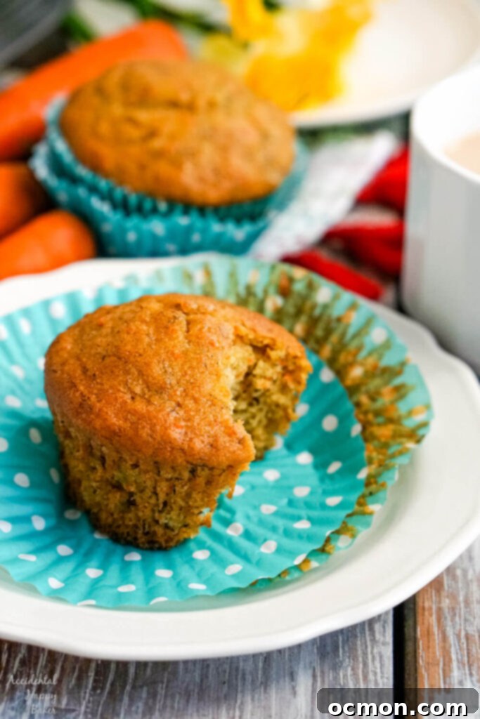 Muffin batter being stirred in a mixing bowl.