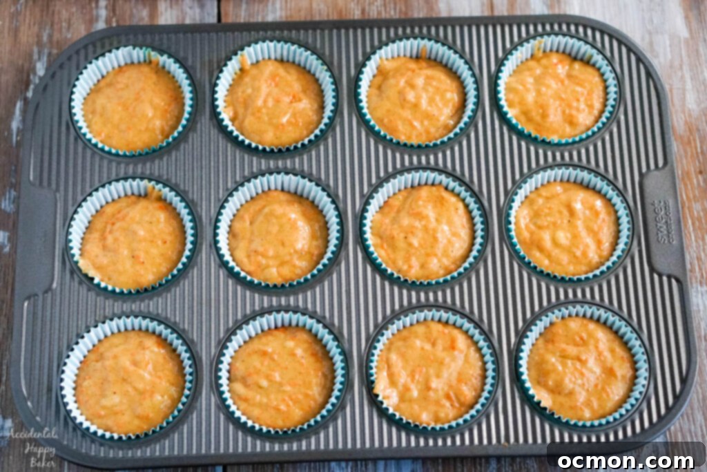 A batch of baked banana carrot muffins cooling on a wire rack.