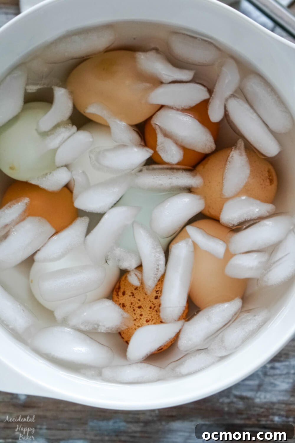 Hard-boiled eggs submerged in an ice bath, cooling down.