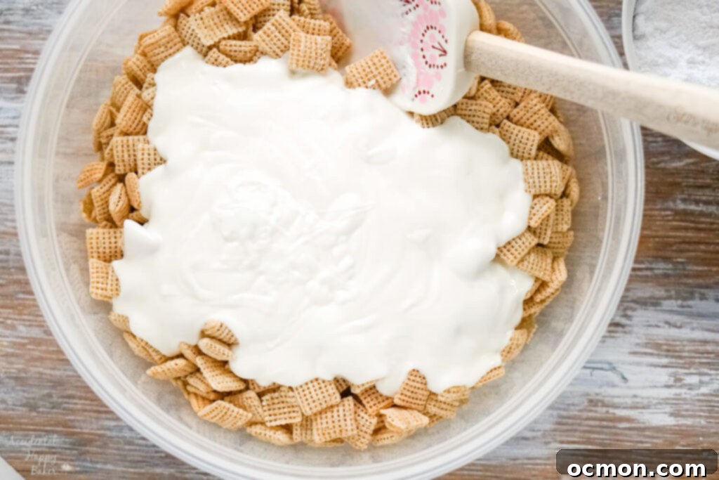 A bowl of chex cereal with melted almond bark poured over it. 