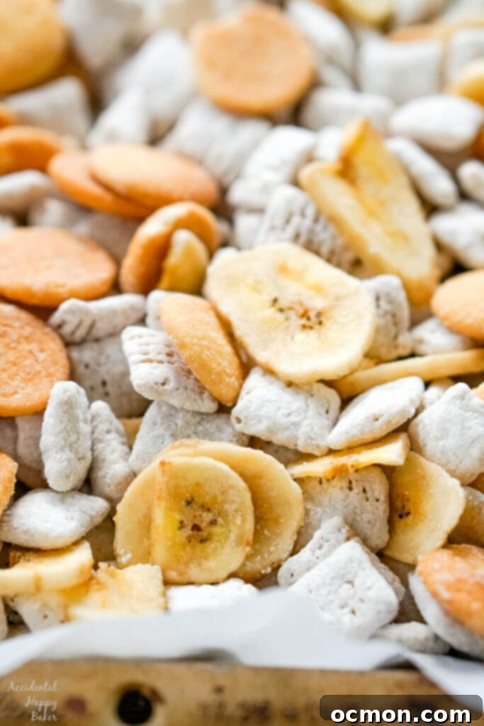 A photo of the finished banana cream pie muddy buddies on a cookie sheet. 