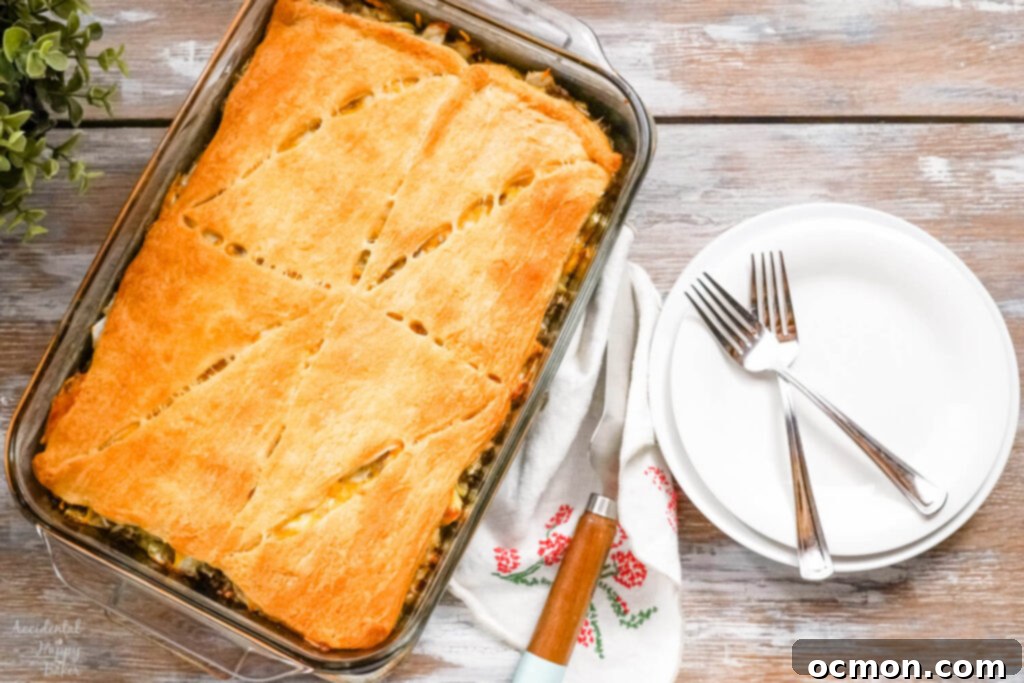 Runza Style Beef and Cabbage Bake 2 A freshly baked Runza casserole next to 2 white plates.
