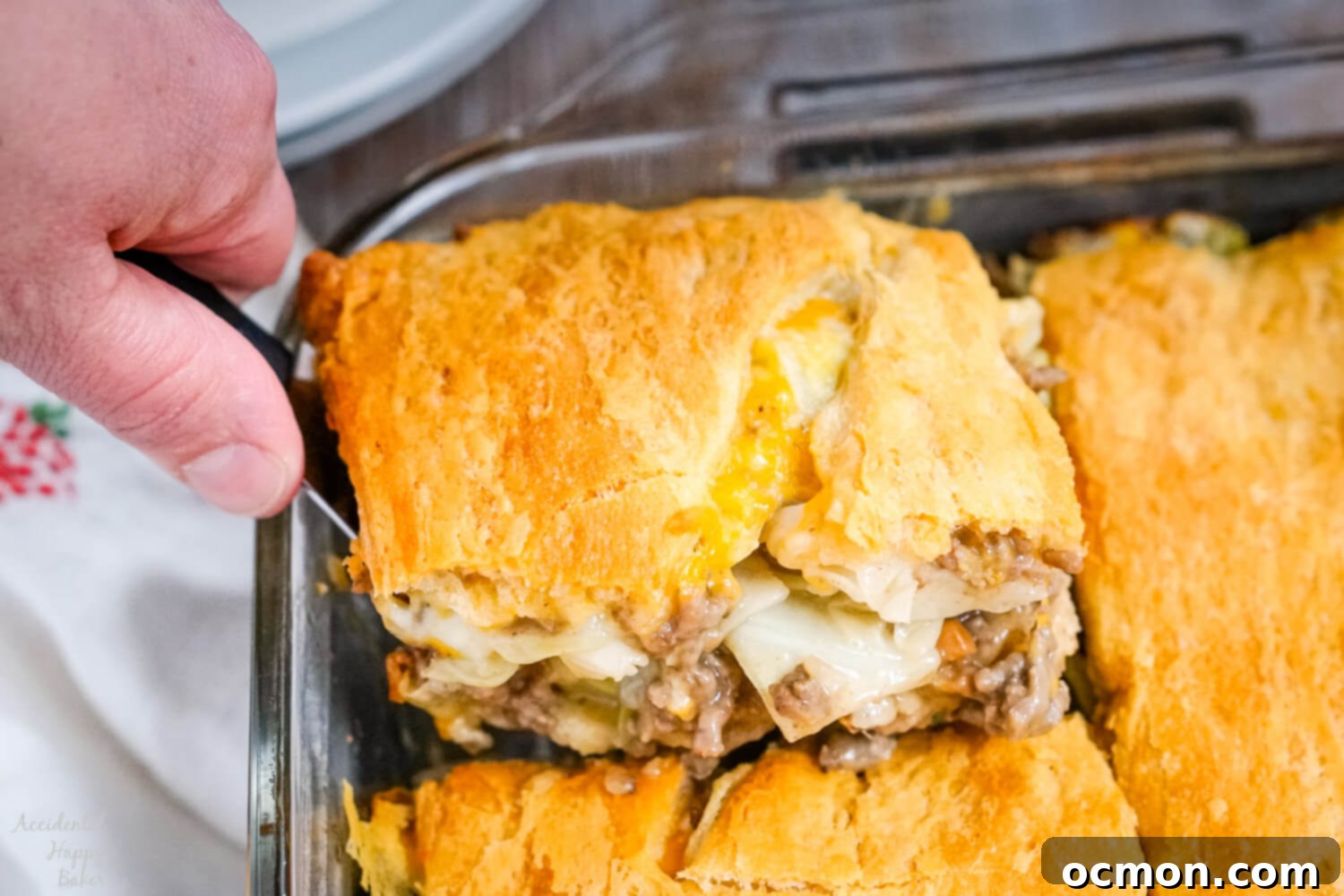 Scooping up a serving of Runza casserole out of the baking dish.