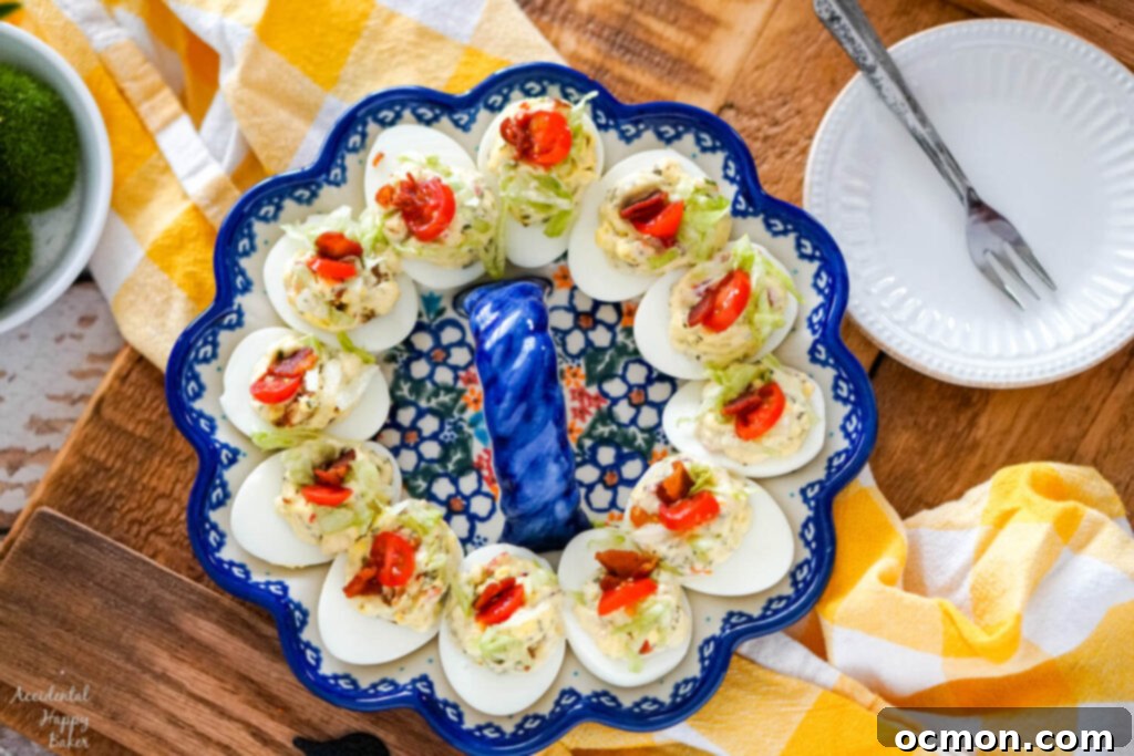 A plate of BLT deviled eggs on a wooden serving tray. Ready to be served at a gathering.