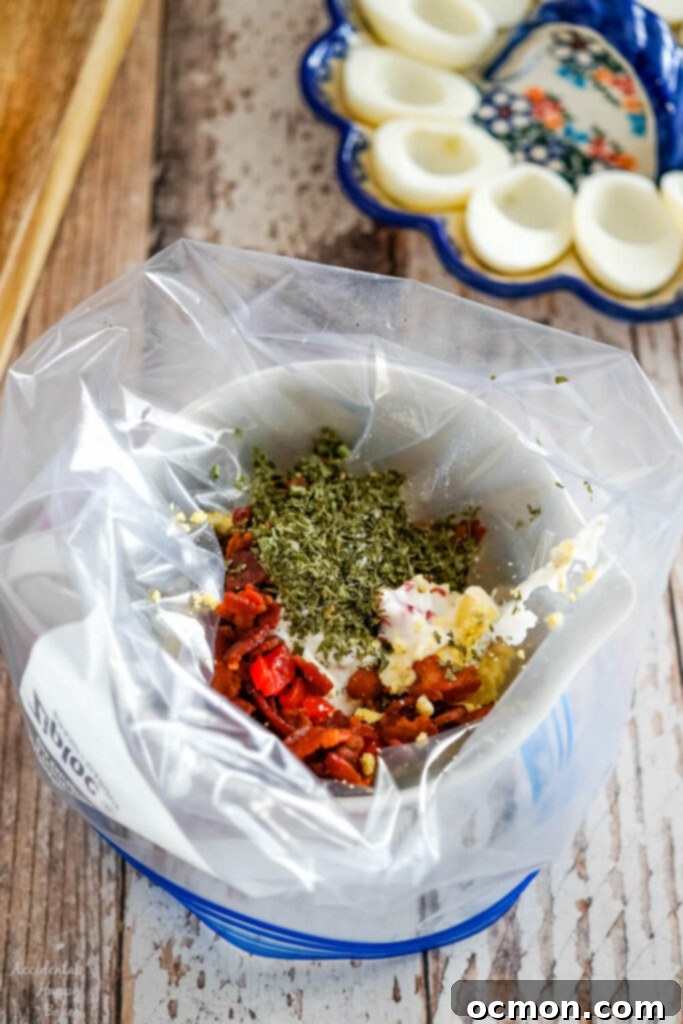 The ingredients for the BLT deviled eggs are added to a ziploc bag to combine. A convenient way to mix.