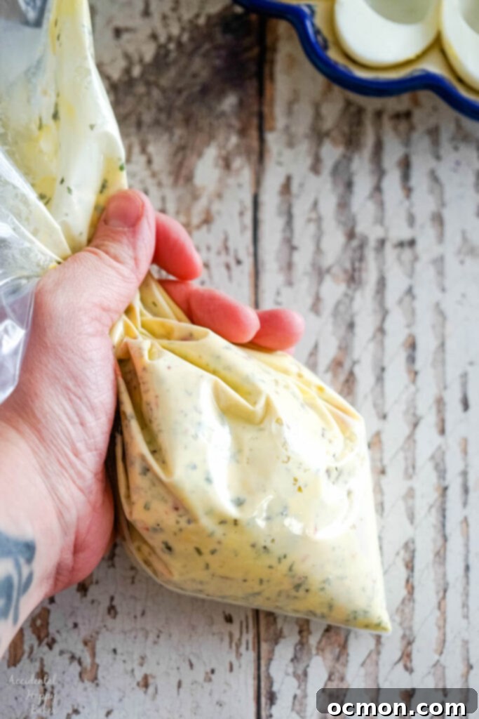 After the ingredients have all been combined in the ziploc bag, snip off the end to pipe. A neat and simple filling technique.