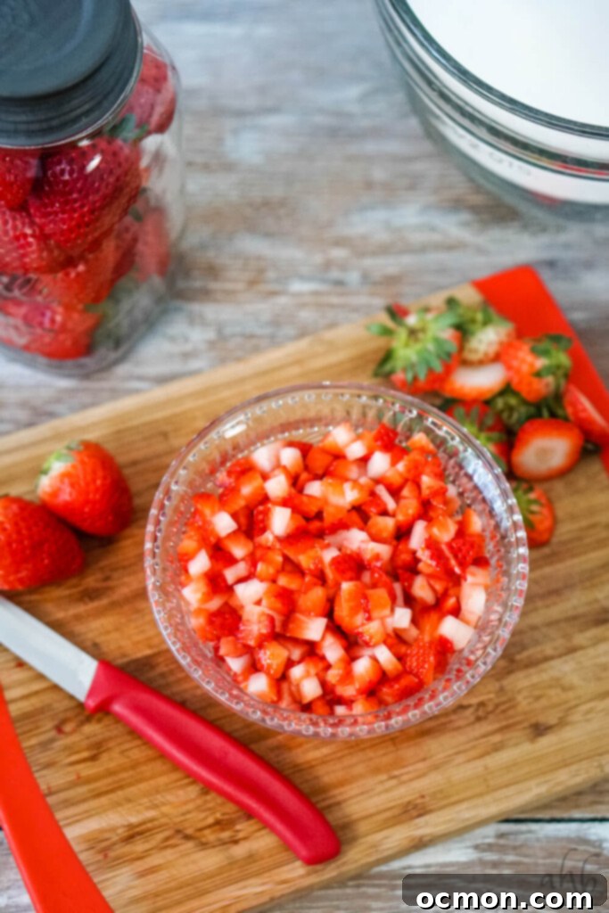 Finely diced fresh strawberries, ready to be incorporated into the bread batter for even distribution and perfect texture.
