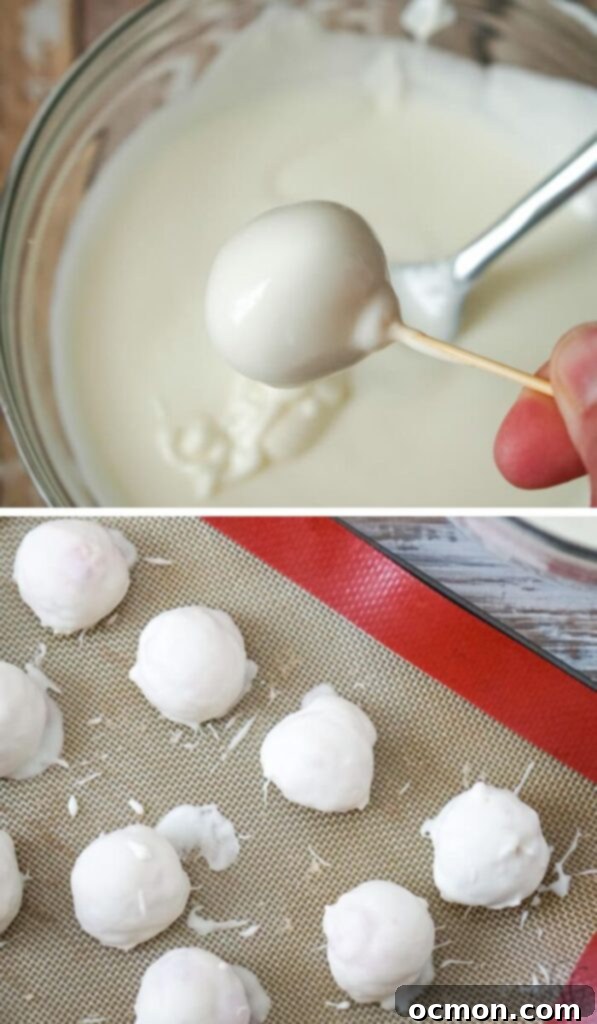 A strawberry cheesecake truffle being dipped into melted vanilla almond bark.