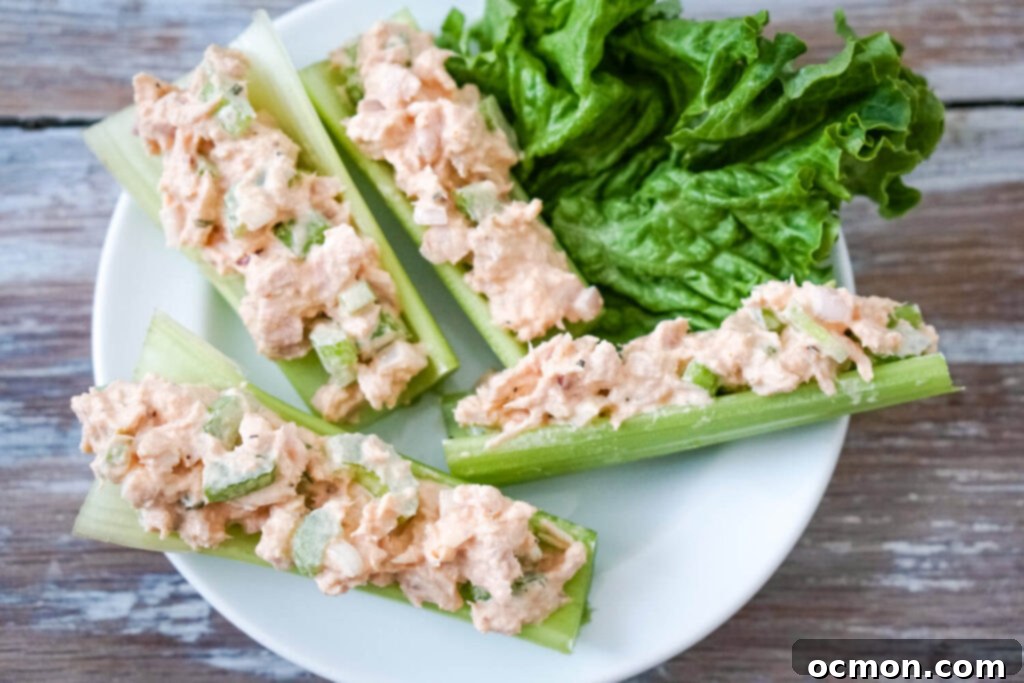Tangy Buffalo Tuna Twist 7 A serving of Buffalo Tuna Salad stuffed into celery sticks, presented on a plate for a healthy snack option.