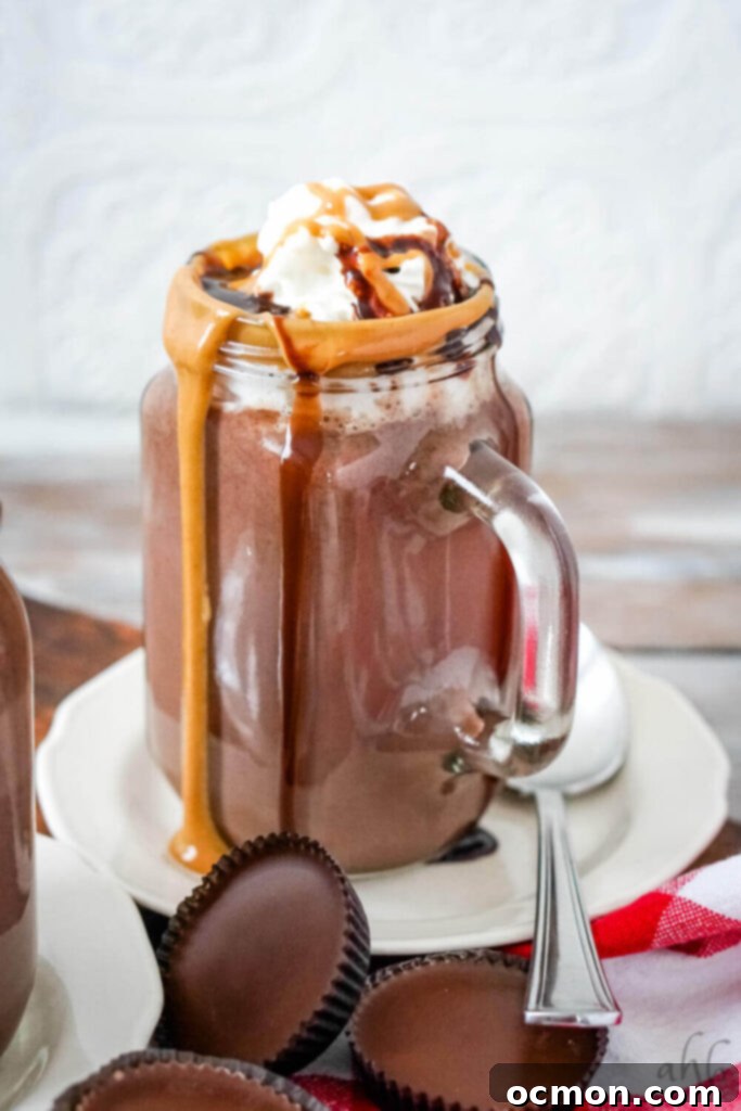 Decadent Peanut Butter Hot Chocolate 2 A beautifully presented mug of peanut butter hot chocolate, topped with whipped cream and a drizzle of chocolate and peanut butter sauce.