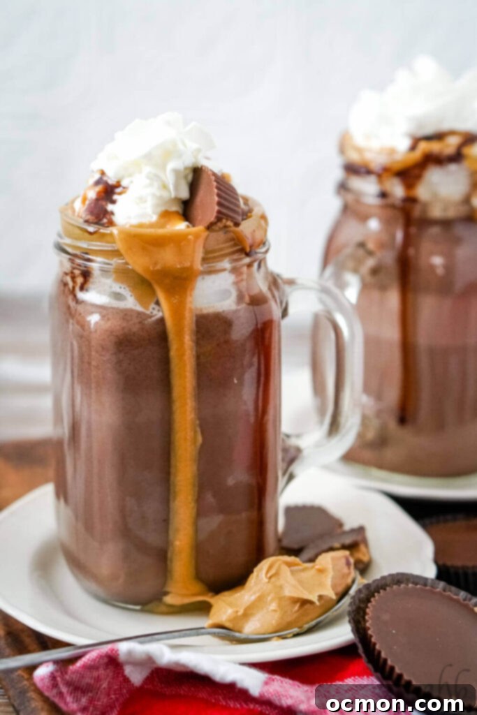 Decadent Peanut Butter Hot Chocolate 3 Close-up of peanut butter hot chocolate in a glass mug, showing its rich, creamy texture and dark chocolate color.