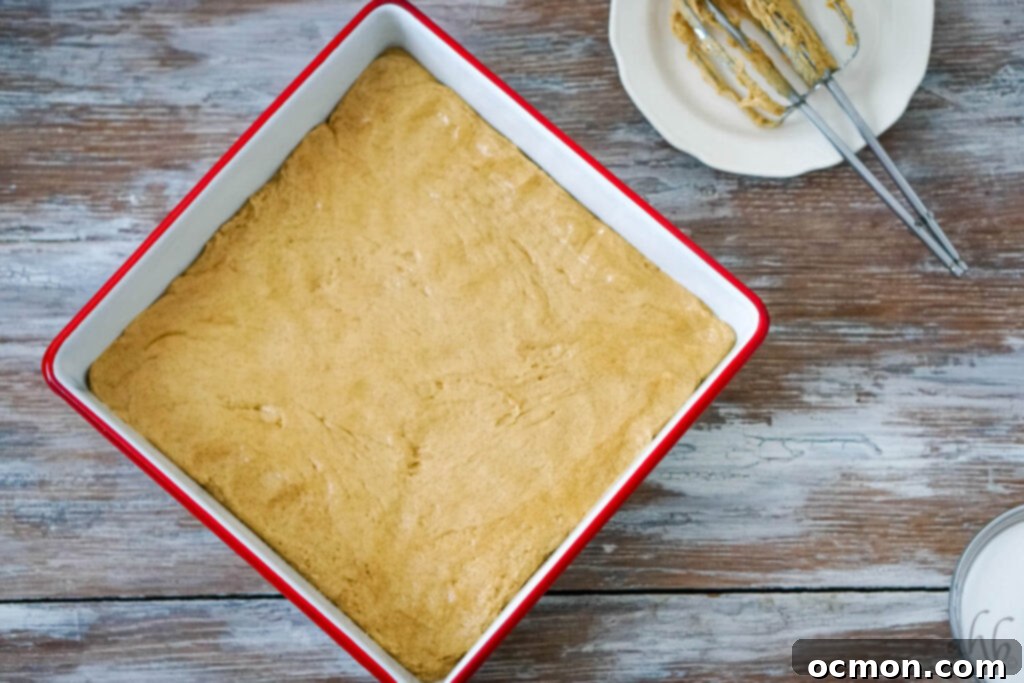 Cinnamon Sugar Churro Bars 6 Pressing the churro bar dough into a 9x9 inch baking pan with greased hands.