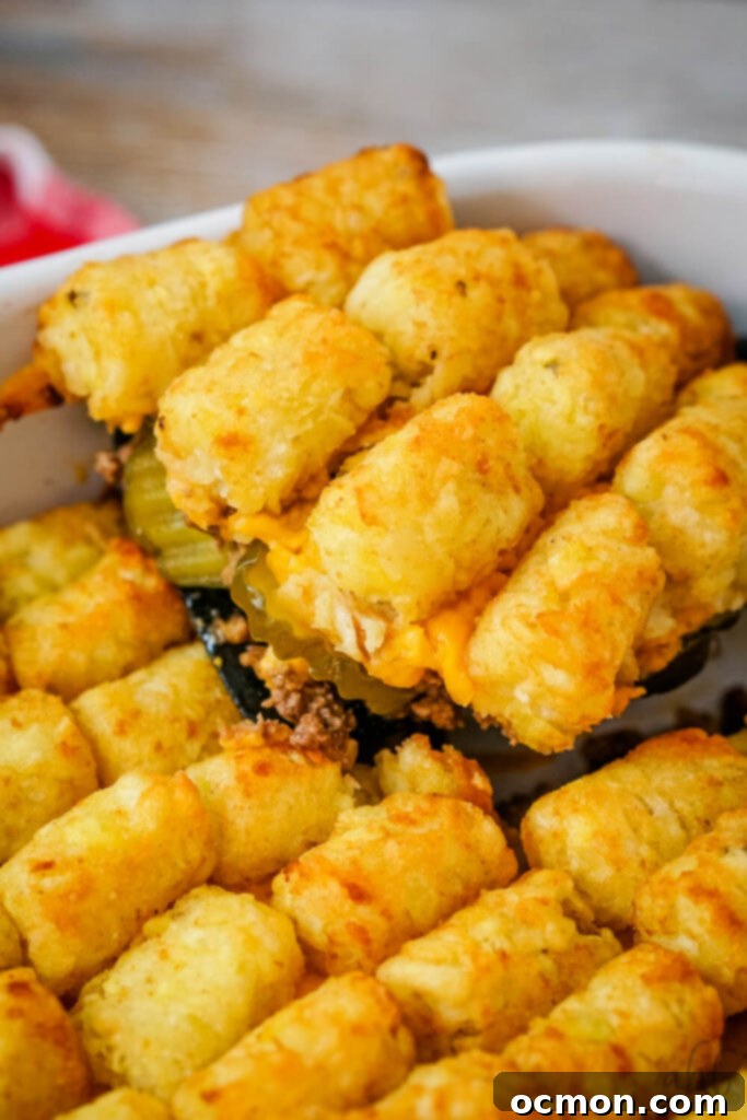 Loaded Big Mac Tater Tot Bake 12 Big Mac Tater Tot casserole is scooped out of the baking dish with a black spatula.